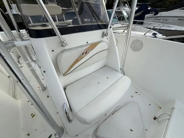 Slide: The Image of 2003 Aquasport Osprey 205 boat interior with white seating and console. - 10