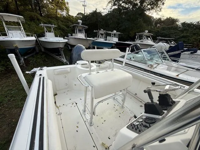 Slide: The Image of 2003 Aquasport Osprey 205 boat interior with white seating and control panel. - 11