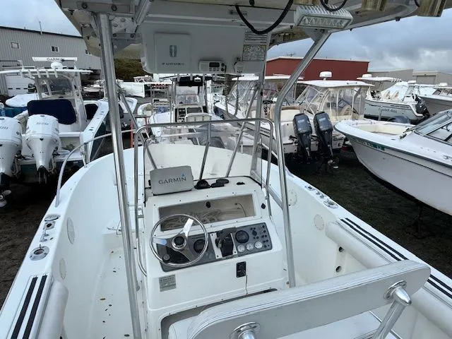 Slide: The Image of 2003 Aquasport Osprey 205 boat with Garmin navigation, docked among other boats. - 4