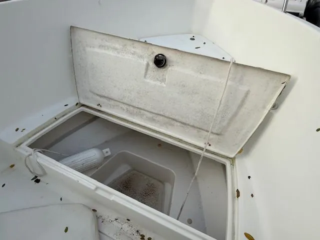 Slide: The Image of Open storage compartment on 2003 Aquasport Osprey 205 boat, showing interior details. - 9