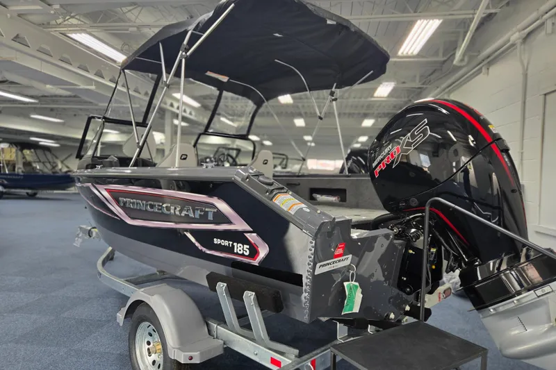 Slide: The Image of 2026 Princecraft Sport 185 boat with Mercury Pro XS engine on display indoors. - 2