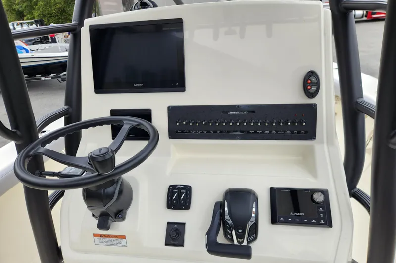 Slide: The Image of 2026 Pathfinder 2400 Open boat console with steering wheel, Garmin display, and control panel. - 11