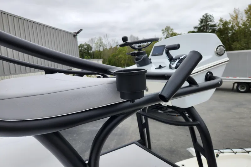 Slide: The Image of 2026 Pathfinder 2400 Open boat console with steering wheel and controls, outdoor setting. - 19