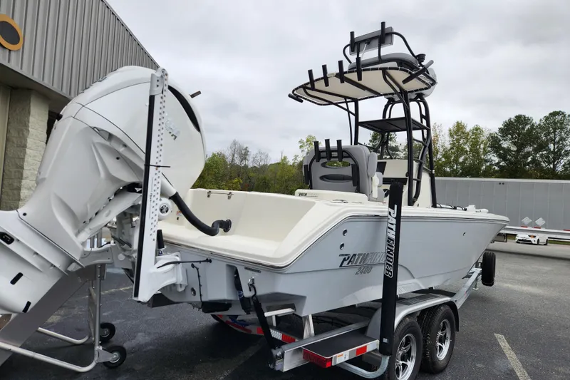 Slide: The Image of 2026 Pathfinder 2400 Open boat on trailer, featuring powerful outboard motor. - 2