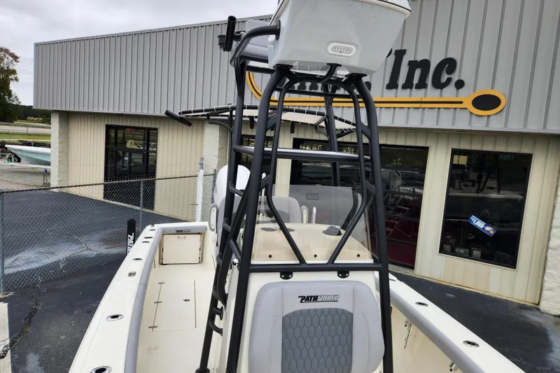 Slide: The Image of 2026 Pathfinder 2400 Open boat with T-top, parked outside a dealership. - 7