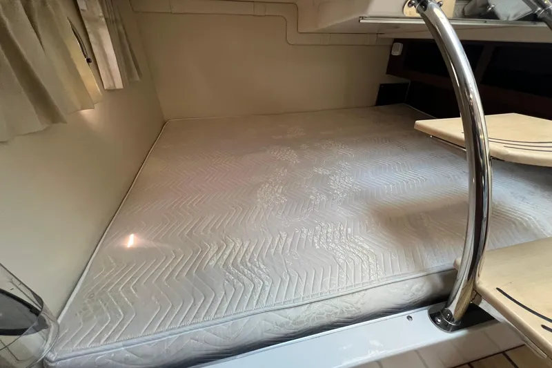 Slide: The Image of Interior cabin of 2014 Regal 28 Express boat with a comfortable mattress. - 20