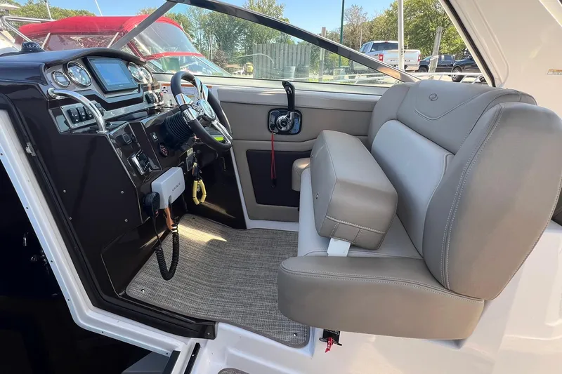 Slide: The Image of 2014 Regal 28 Express boat interior with steering wheel and seating area. - 22