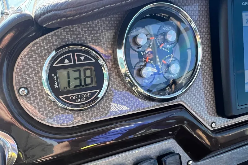 Slide: The Image of Dashboard of a 2014 Regal 28 Express boat with digital and analog gauges. - 23