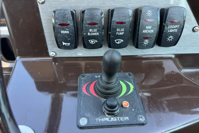 Slide: The Image of Control panel of a 2014 Regal 28 Express boat with switches and thruster joystick. - 29