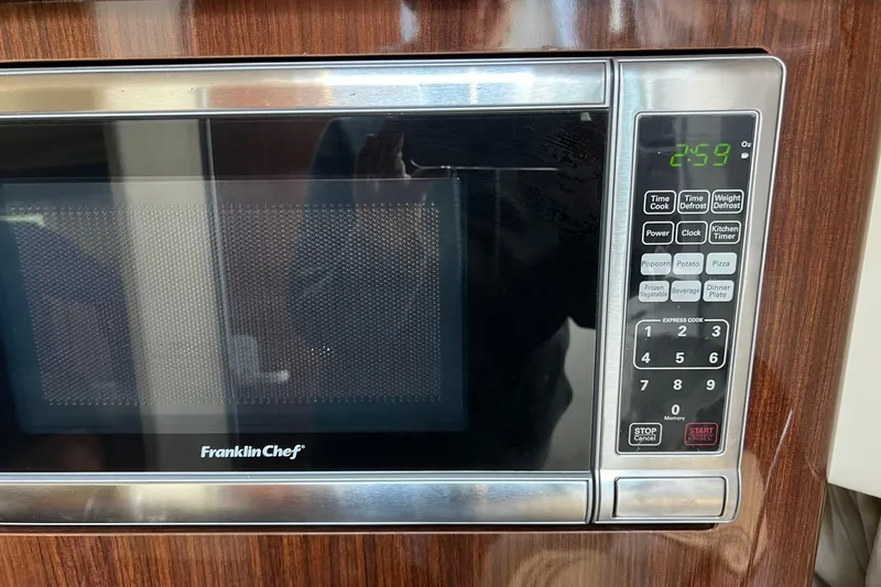 Slide: The Image of Franklin Chef microwave with digital display and control panel, installed in a 2014 Regal 28 Express. - 33