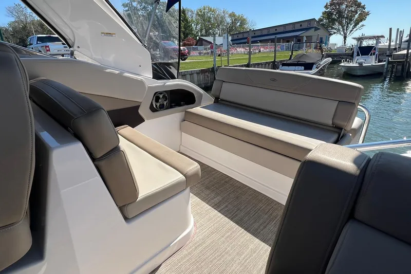 Slide: The Image of 2014 Regal 28 Express boat interior with beige seating and waterfront view. - 5