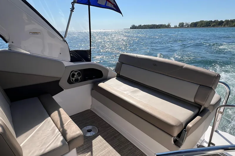 Slide: The Image of 2014 Regal 28 Express boat interior with seating, cruising on a sunny day. - 7