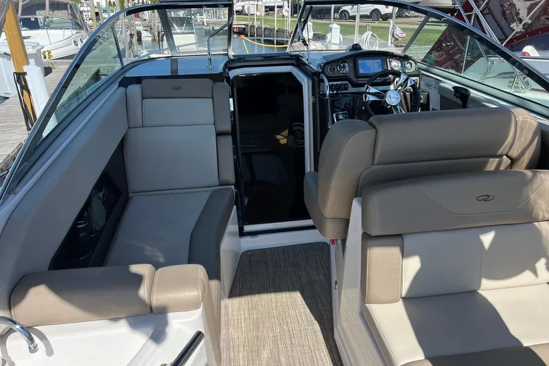 Slide: The Image of 2014 Regal 28 Express boat interior with seating and steering wheel. - 9