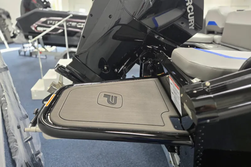 Slide: The Image of 2026 Princecraft Sport 188 boat with Mercury engine, featuring a sleek black design and comfortable seating. - 11