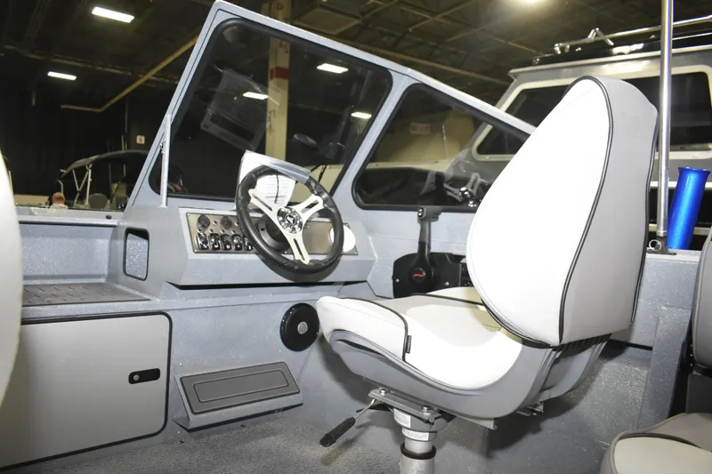 Slide: The Image of Interior of 2026 KingFisher 1825 Falcon boat with steering wheel and seat. - 25