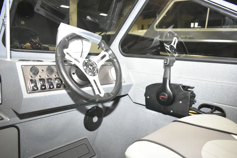 Slide: The Image of Interior of 2026 KingFisher 1825 Falcon boat with steering wheel and controls. - 26