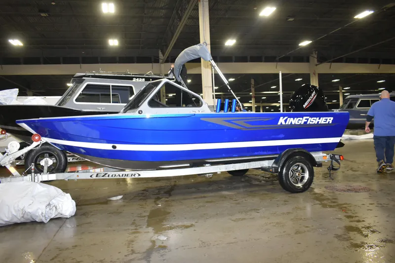 The Image of 2026 KingFisher 1825 Falcon boat on trailer in indoor showroom. - 9