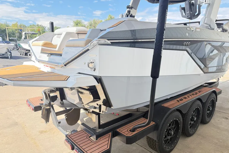 Slide: The Image of 2022 Nautique Super Air Nautique G23 boat on trailer, rear view, sunny day. - 14