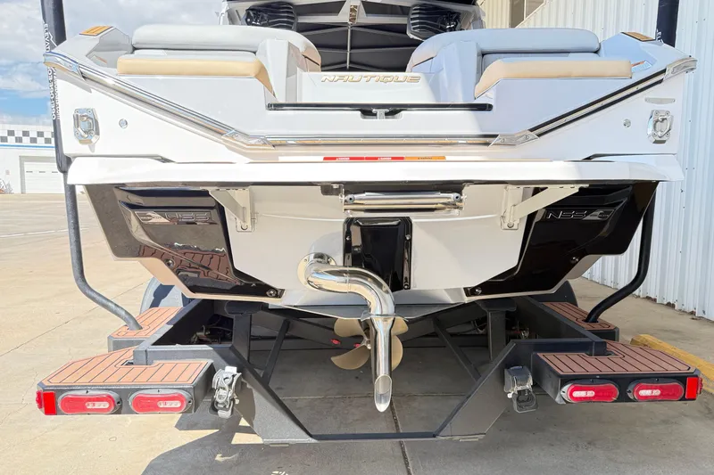 Slide: The Image of 2022 Nautique Super Air Nautique G23 boat rear view on trailer. - 17