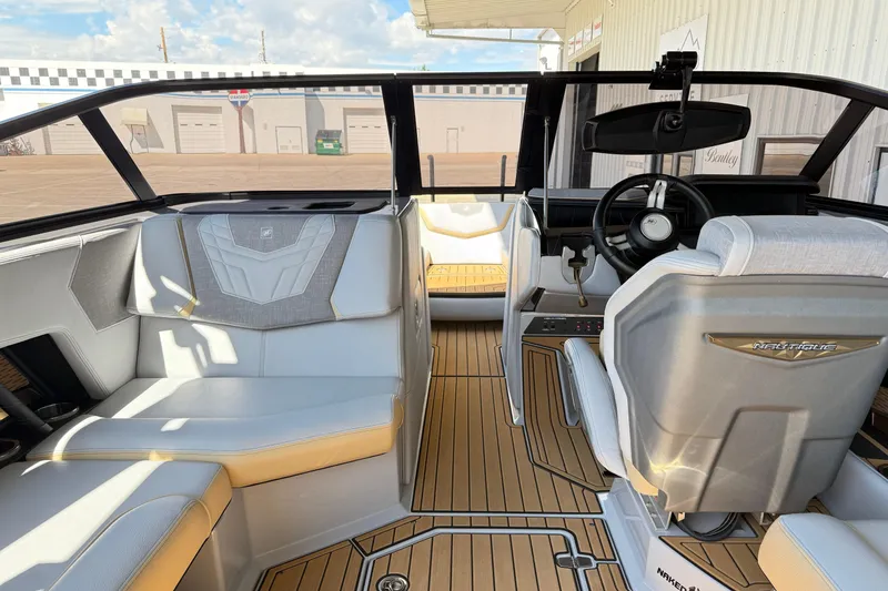 Slide: The Image of 2022 Nautique Super Air Nautique G23 interior with luxurious seating and modern dashboard. - 19