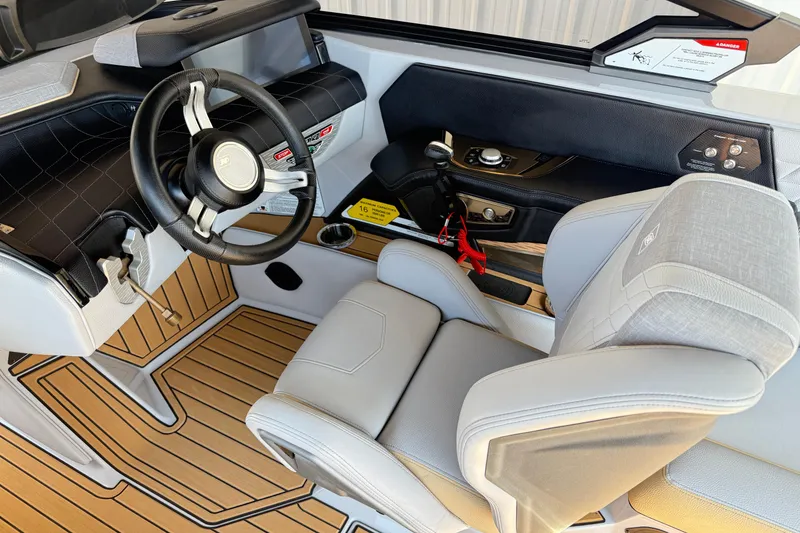 Slide: The Image of 2022 Nautique Super Air Nautique G23 cockpit with modern steering and controls. - 21