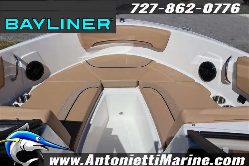 Slide: The Image of 2026 Bayliner V20 boat interior with tan seating, speakers, and cup holders. - 12