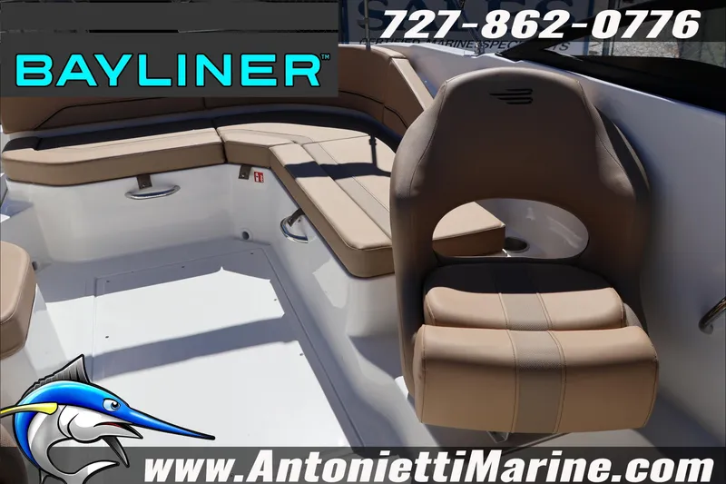 Slide: The Image of Interior of 2026 Bayliner V20 boat with tan seating, logo, and contact details. - 15