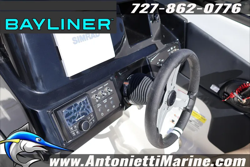 Slide: The Image of 2026 Bayliner V20 boat dashboard with steering wheel and Simrad navigation system. - 18