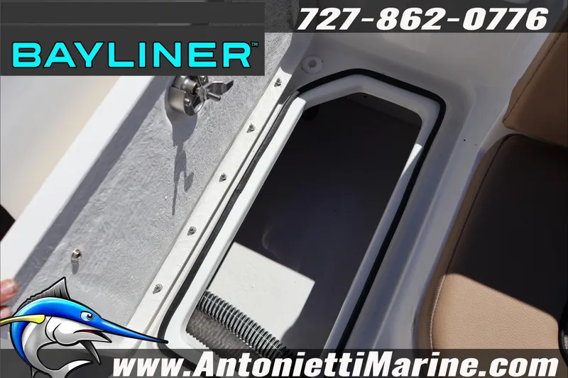 Slide: The Image of 2026 Bayliner V20 boat storage compartment, open lid, with contact details and logo. - 27