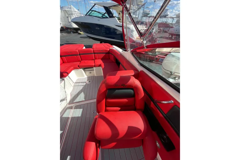Slide: The Image of 2014 Sea Ray 270 SLX boat interior with vibrant red seating and sleek design. - 11