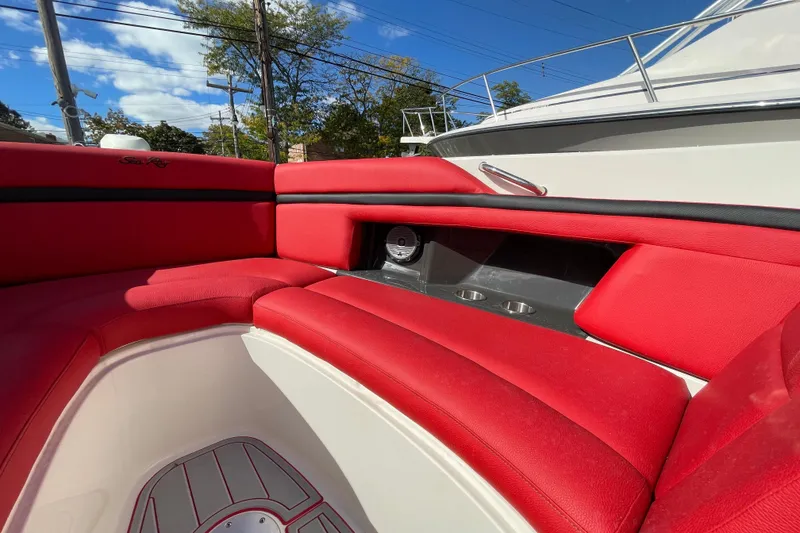 Slide: The Image of Red seating area on 2014 Sea Ray 270 SLX boat, featuring cup holders and speaker. - 3