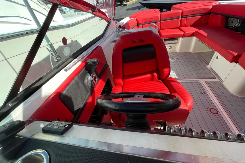 Slide: The Image of 2014 Sea Ray 270 SLX boat interior with red seating and steering wheel. - 9