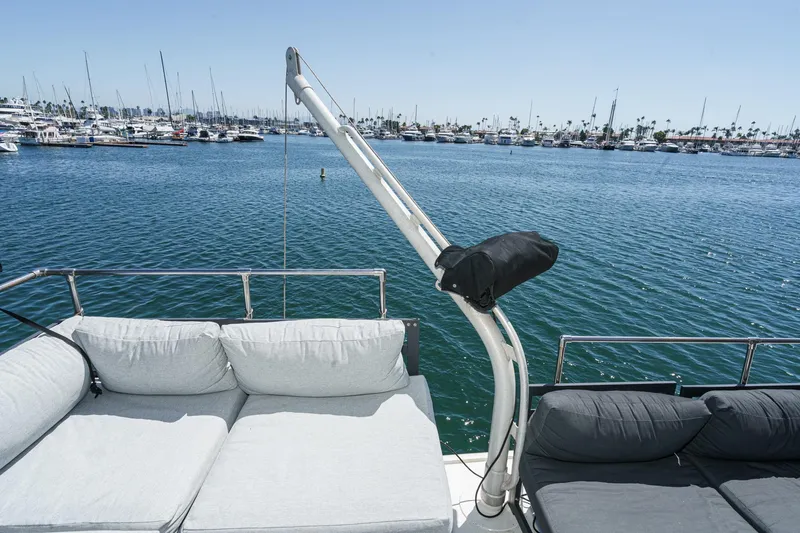 Slide: The Image of 1979 Hatteras 58 Motor Yacht deck with comfortable seating, overlooking marina. - 19