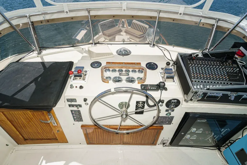 Slide: The Image of 1979 Hatteras 58 Motor Yacht helm with steering wheel, controls, and audio equipment. - 22