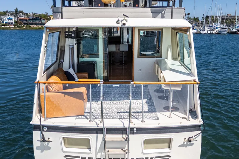 Slide: The Image of 1979 Hatteras 58 Motor Yacht with spacious deck and comfortable seating on the water. - 29