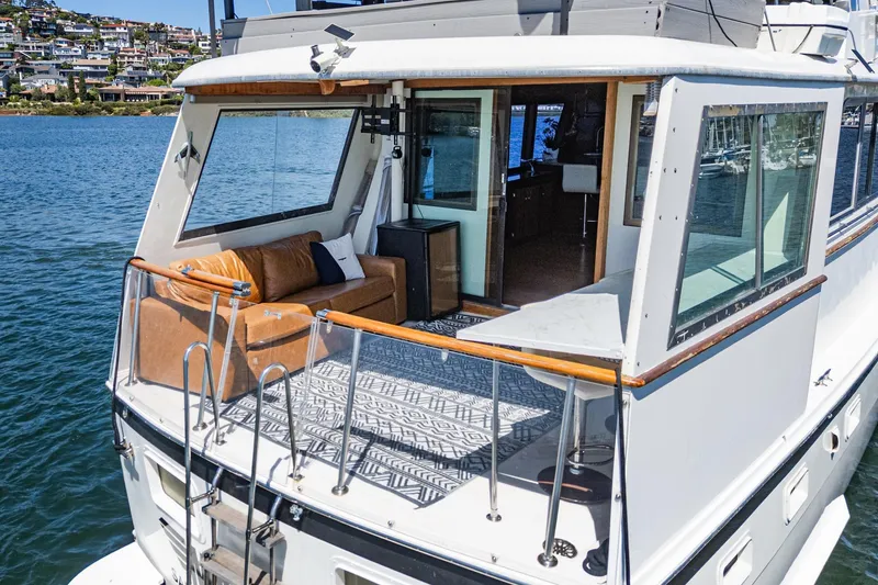 Slide: The Image of 1979 Hatteras 58 Motor Yacht with elegant deck and scenic waterfront view. - 30