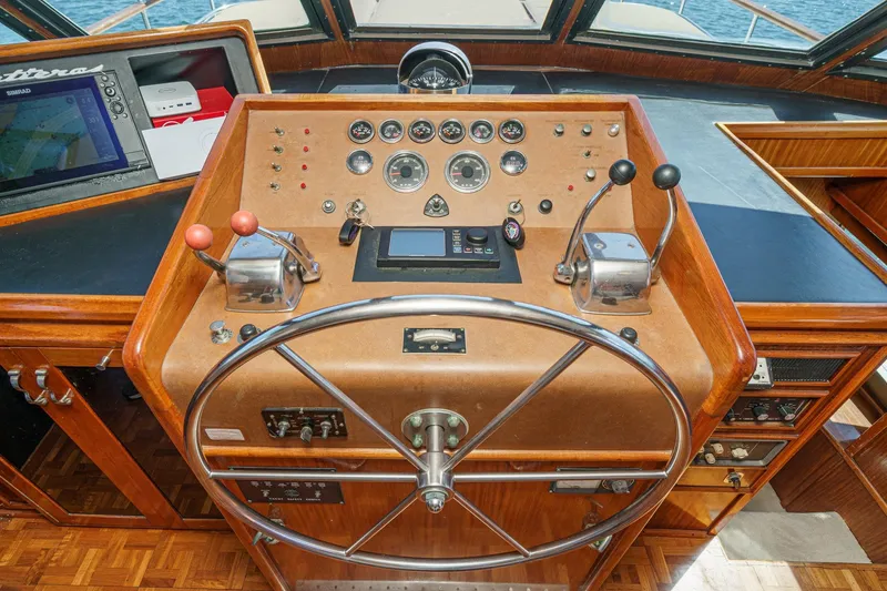 Slide: The Image of 1979 Hatteras 58 Motor Yacht helm with classic wooden dashboard and navigation instruments. - 44