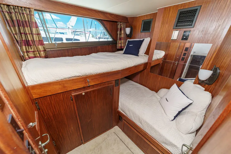Slide: The Image of 1979 Hatteras 58 Motor Yacht cabin with wooden interior and bunk beds. - 48