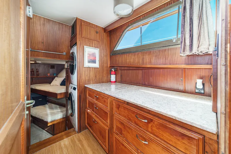 Slide: The Image of Interior of 1979 Hatteras 58 Motor Yacht with wood cabinetry and laundry area. - 49