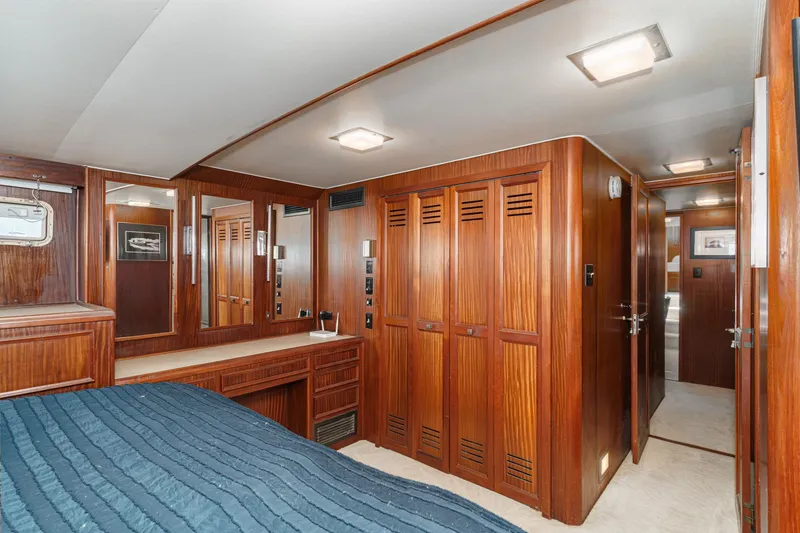 Slide: The Image of Interior of 1979 Hatteras 58 Motor Yacht with wood paneling and cozy bedroom. - 59