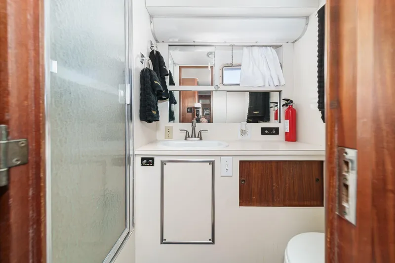 Slide: The Image of Bathroom interior of 1979 Hatteras 58 Motor Yacht with sink, mirror, and shower. - 61