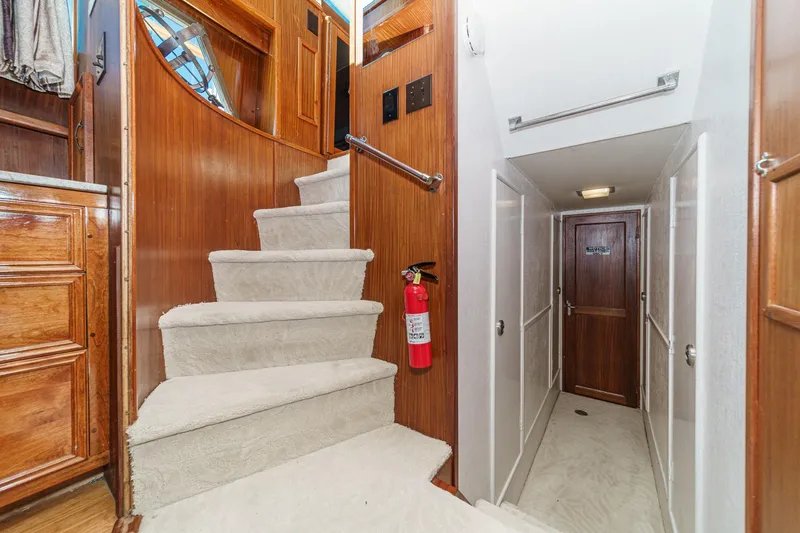Slide: The Image of Interior of 1979 Hatteras 58 Motor Yacht with carpeted stairs and wooden paneling. - 63