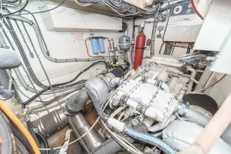 Slide: The Image of Engine room of a 1979 Hatteras 58 Motor Yacht with visible machinery and wiring. - 68