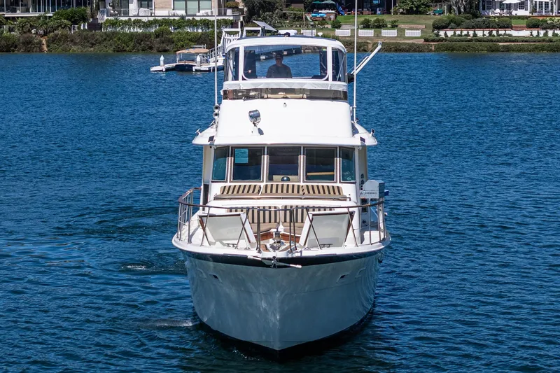 Slide: The Image of 1979 Hatteras 58 Motor Yacht cruising on a serene blue lake. - 7