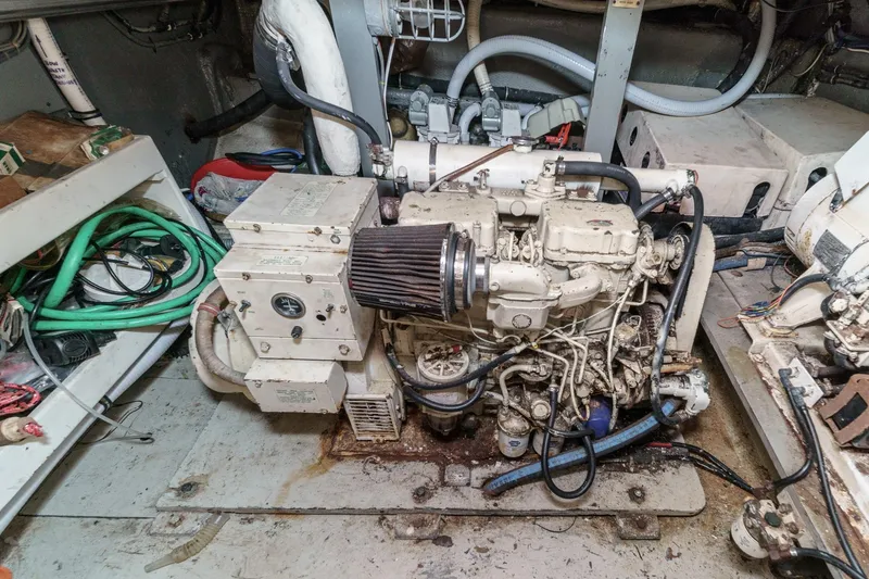 Slide: The Image of Engine room of a 1979 Hatteras 58 Motor Yacht with visible machinery and wiring. - 70