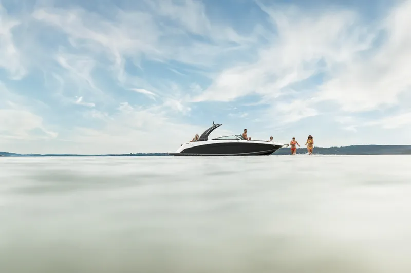 Slide: The Image of 2026 Four Winns HD8 OB boat on water with people enjoying a sunny day. - 10