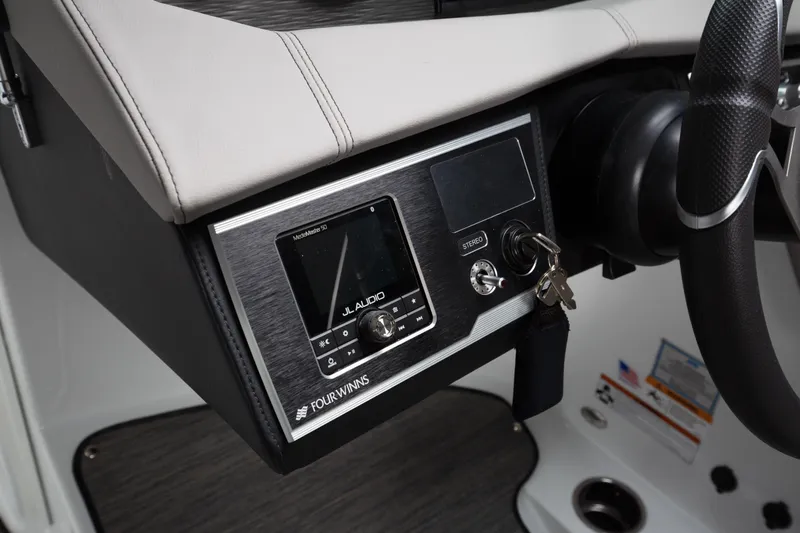 Slide: The Image of 2026 Four Winns HD8 OB dashboard with JL Audio system and steering wheel. - 17