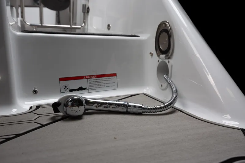 Slide: The Image of 2026 Four Winns HD8 OB boat deck with chrome shower hose and warning label. - 24