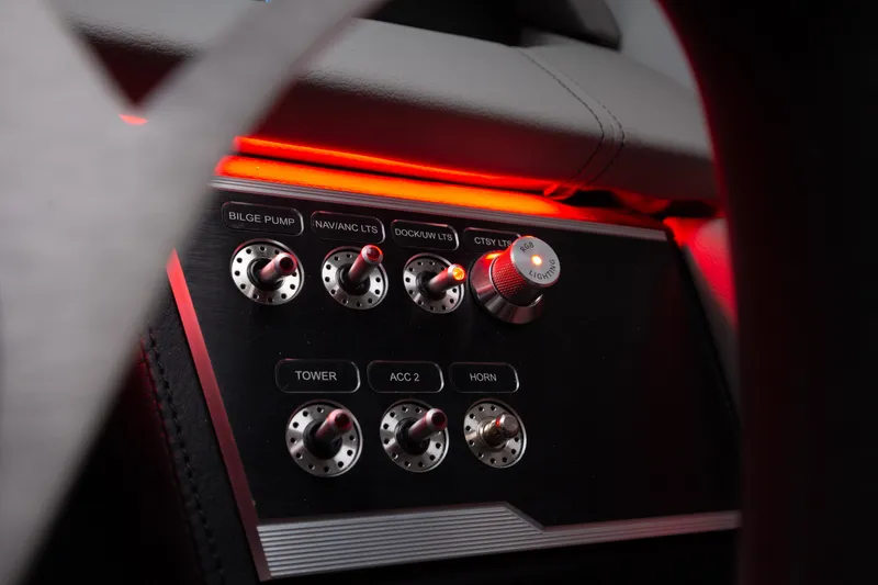 Slide: The Image of Control panel of 2026 Four Winns HD8 OB boat with illuminated switches and knobs. - 29