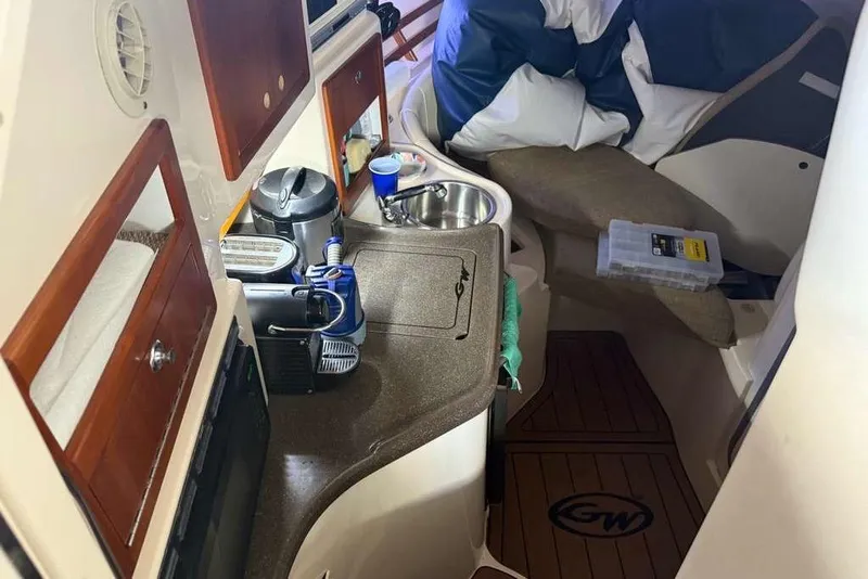 Slide: The Image of Interior of 2007 Grady-White Express 305 boat with white seating and wooden flooring. - 15